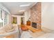 Inviting living room with vaulted ceilings, brick fireplace, and hardwood floors at 4017 Huckleberry Dr, Raleigh, NC 27612