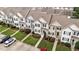 An aerial view of townhouse exteriors with well-maintained lawns and manicured landscaping at 407 Whitehall Ct, Clayton, NC 27520