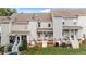 A view of multiple townhomes, each featuring a rear porch and well-maintained lawn at 407 Whitehall Ct, Clayton, NC 27520