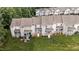 A view of multiple townhomes, each featuring a rear porch and well-maintained lawn at 407 Whitehall Ct, Clayton, NC 27520