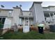 Townhome backyard featuring a small porch, outdoor access to a basement, and minimal grass at 407 Whitehall Ct, Clayton, NC 27520