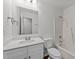 Bright bathroom featuring white vanity with chrome faucet, matching toilet, and shower at 407 Whitehall Ct, Clayton, NC 27520