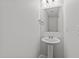 Modern powder room features pedestal sink and sleek fixtures at 407 Whitehall Ct, Clayton, NC 27520