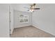 Bright bedroom featuring a ceiling fan, a window, neutral carpet, and white walls at 407 Whitehall Ct, Clayton, NC 27520