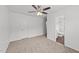 Bright bedroom featuring a ceiling fan, neutral carpet, and an ensuite bathroom at 407 Whitehall Ct, Clayton, NC 27520