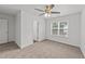 Bright bedroom featuring a ceiling fan, a window, neutral carpet, and white walls at 407 Whitehall Ct, Clayton, NC 27520