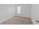 A bedroom with neutral carpet, a window with blinds, and white walls at 407 Whitehall Ct, Clayton, NC 27520