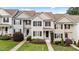 Well-maintained townhouse with neutral siding, black shutters, and a landscaped front yard at 407 Whitehall Ct, Clayton, NC 27520