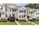 Townhouse exterior showcasing a manicured lawn and tidy landscaping at 407 Whitehall Ct, Clayton, NC 27520