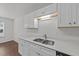 This kitchen features a stainless steel sink, white cabinets, and a dishwasher at 407 Whitehall Ct, Clayton, NC 27520