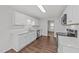 Bright, modern kitchen showcasing stainless steel appliances and sleek white cabinetry at 407 Whitehall Ct, Clayton, NC 27520