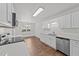 Clean and modern kitchen with stainless steel appliances, white cabinets, and light countertops at 407 Whitehall Ct, Clayton, NC 27520