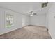 Spacious living room with new carpet, ceiling fan and view to backyard at 407 Whitehall Ct, Clayton, NC 27520