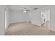 Living room features a ceiling fan, carpet, and an open floor plan at 407 Whitehall Ct, Clayton, NC 27520