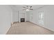 Bright living room features a fireplace, access to the backyard, and a ceiling fan at 407 Whitehall Ct, Clayton, NC 27520