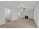 Cozy living room features a fireplace, carpet, and ceiling fan at 407 Whitehall Ct, Clayton, NC 27520