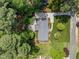 Aerial view of home showcasing expansive yard, patio area, mature trees, and winding driveway at 4112 Huckleberry Dr, Raleigh, NC 27612