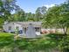 View of backyard with a white brick outdoor fireplace, grill, and fence at 4112 Huckleberry Dr, Raleigh, NC 27612