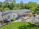 A covered patio with cozy seating area, grilling area, and fenced-in yard for outdoor enjoyment at 4112 Huckleberry Dr, Raleigh, NC 27612