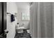 This full bathroom features black hexagonal tile and plantation shutters at 4112 Huckleberry Dr, Raleigh, NC 27612