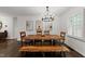Bright dining room featuring a chandelier and a wood table and bench for seating at 4112 Huckleberry Dr, Raleigh, NC 27612