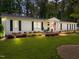 Charming white brick home with manicured lawn and mature trees offers classic curb appeal at 4112 Huckleberry Dr, Raleigh, NC 27612