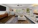 Cozy living room with a large sectional sofa, hardwood floors, and natural light at 4112 Huckleberry Dr, Raleigh, NC 27612