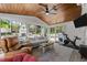 Bright sunroom with vaulted wood ceilings, comfortable seating, and views of the backyard at 4112 Huckleberry Dr, Raleigh, NC 27612