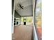 Large screened back porch with wood decking, ceiling fan, and great natural light at 425 Price Ave, Durham, NC 27707