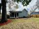 Expansive backyard with lawn, a screen door porch, landscape features, and mature trees at 425 Price Ave, Durham, NC 27707