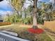 Well maintained backyard features privacy fence, beautiful trees, and colorful mulch at 425 Price Ave, Durham, NC 27707