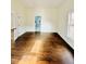 Bright bedroom with gleaming hardwood floors and view into updated bathroom at 425 Price Ave, Durham, NC 27707