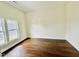 Sunlit bedroom boasts gleaming hardwood floors and double windows, creating a warm, inviting atmosphere at 425 Price Ave, Durham, NC 27707