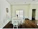 Light-filled dining room with wood floors and door to the outdoor deck at 425 Price Ave, Durham, NC 27707
