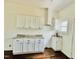 Renovated kitchen features granite counters, white cabinets, and a stainless vent hood at 425 Price Ave, Durham, NC 27707