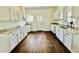 Bright kitchen with white cabinets, granite countertops, and dark hardwood floors at 425 Price Ave, Durham, NC 27707