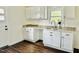 Bright kitchen features granite counters, stainless faucet, and white shaker cabinets at 425 Price Ave, Durham, NC 27707