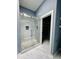 Beautiful glass enclosed shower with stone base and subway tile surround at 425 Price Ave, Durham, NC 27707