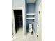 Stylish bathroom features a toilet and floating shelves next to a walk-in closet at 425 Price Ave, Durham, NC 27707