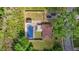 Aerial view showcasing the house, backyard with covered pool, deck, privacy fence, and greenery at 464 Camp Rd, Burlington, NC 27217