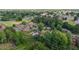 Overhead view of a green, residential neighborhood featuring mature trees and well-maintained homes and landscaping at 464 Camp Rd, Burlington, NC 27217