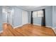 Cozy bedroom with light-blue walls, hardwood floors, closet, and natural light at 464 Camp Rd, Burlington, NC 27217