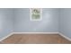 Bedroom showcasing light blue walls, carpeted flooring, base trim, and a sunlit window at 464 Camp Rd, Burlington, NC 27217