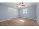 Cozy bedroom featuring two windows for natural light and a ceiling fan for added comfort at 464 Camp Rd, Burlington, NC 27217