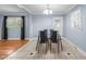 View of dining area, displaying hardwood floors, tile and natural light from the windows at 464 Camp Rd, Burlington, NC 27217