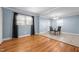 Bright dining area with hardwood floors and tile, perfect for gatherings with natural light from multiple windows at 464 Camp Rd, Burlington, NC 27217