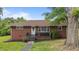 Charming single-story brick home with landscaped front yard and mature trees, creating curb appeal at 464 Camp Rd, Burlington, NC 27217