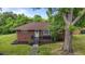 Single-story brick home with mature trees, well-maintained lawn, and inviting front entrance at 464 Camp Rd, Burlington, NC 27217