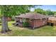 Brick home with a red roof, showing manicured landscaping and a small black porch with stairs at 464 Camp Rd, Burlington, NC 27217