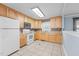 Kitchen with ample cabinetry, modern appliances, and tile floors, creating a functional cooking space at 464 Camp Rd, Burlington, NC 27217